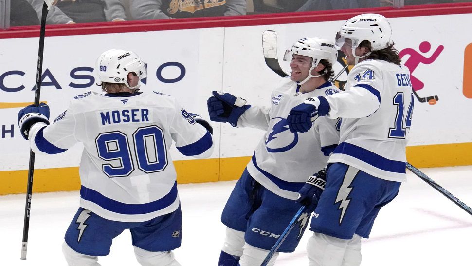 Tampa Bay Lightning's Brayden Point, center, celebrates with J.J. Moser (90) and Conor Geekie (14) after getting the game-winning overtime goal during an NHL hockey game against the Pittsburgh Penguins, Tuesday, Nov. 19, 2024, in Pittsburgh. The Lightning won 3-2. (AP Photo/Gene J. Puskar)