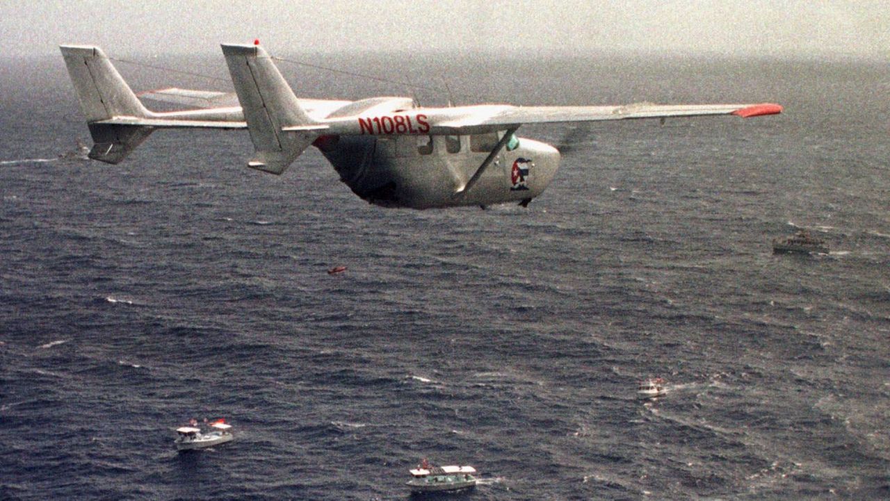 A Brothers to the Rescue plane flies over The Democracy Movement flotilla at the twelve-mile limit north of Havana, Cuba, July 10, 1999. (AP Photo/Alan Diaz, File)