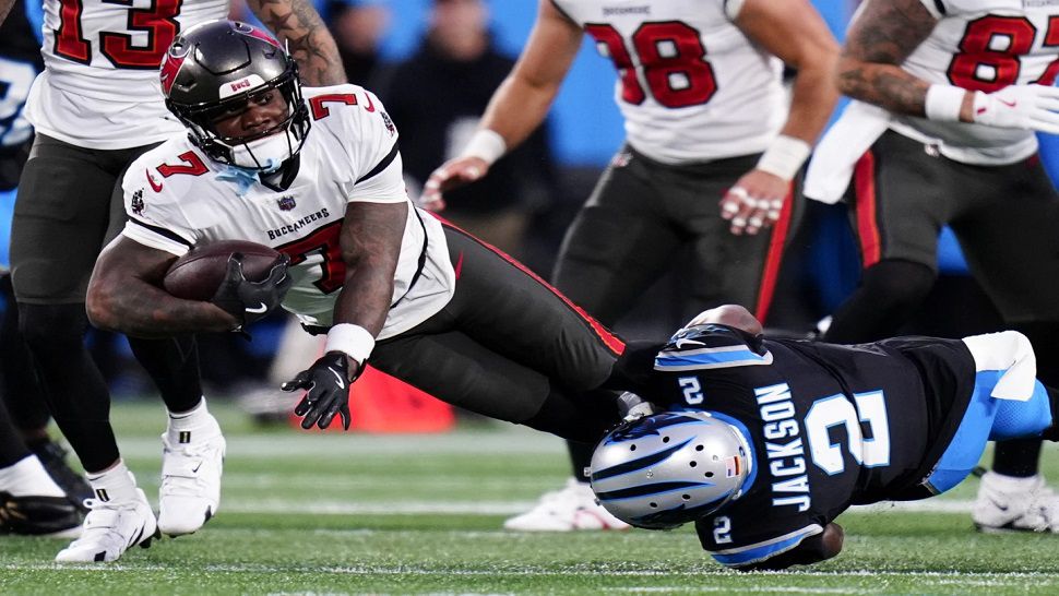 Tampa Bay Buccaneers running back Bucky Irving is tackled by Carolina Panthers cornerback Michael Jackson during the first half of an NFL football game, Sunday, Dec. 1, 2024, in Charlotte, N.C. (AP Photo/Rusty Jones)