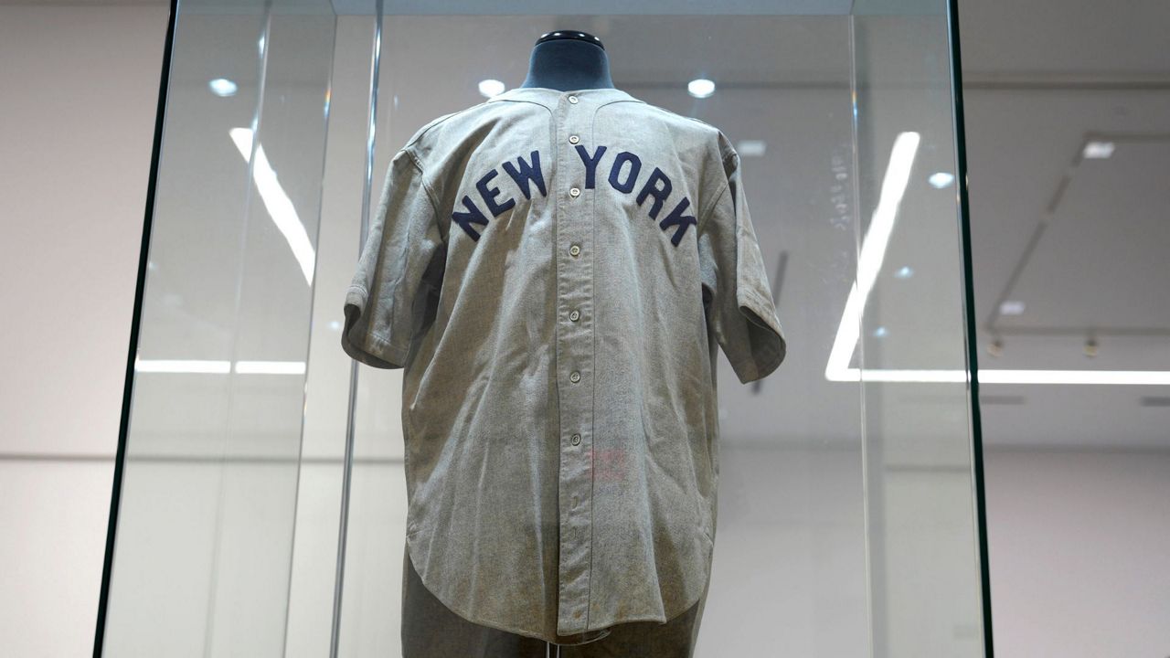 The 1932 Babe Ruth game worn New York Yankees World Series "Called Shot" jersey is displayed in a sealed glass box at Heritage Auction in Irving, Texas, Wednesday, Aug. 21, 2024. (AP Photo/LM Otero)