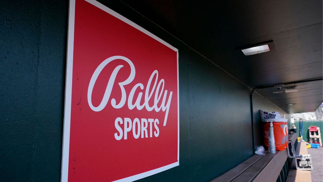 A Bally Sports logo is shown in the dugout during a spring training baseball game at Roger Dean Stadium, Saturday, March 4, 2023, in Jupiter, Fla. (AP Photo/Lynne Sladky, File)