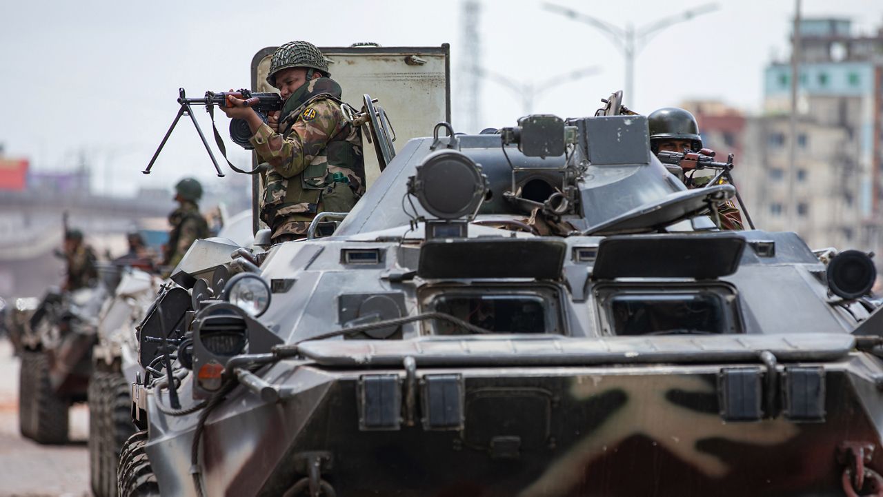 Bangladeshi military forces on armored vehicles patrol on the streets of Dhaka, Bangladesh, Saturday, July 20, 2024. Bangladeshi authorities extended a curfew across the country on Sunday as the nation's top court was expected to rule on a civil service hiring quota that has led to days of deadly clashes between police and protesters, killing scores of people. (AP Photo/Rajib Dhar)