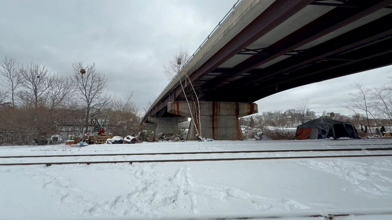 Tents at Bangor’s railroad encampment under the State Street Bridge. (Spectrum News/David Ledford)