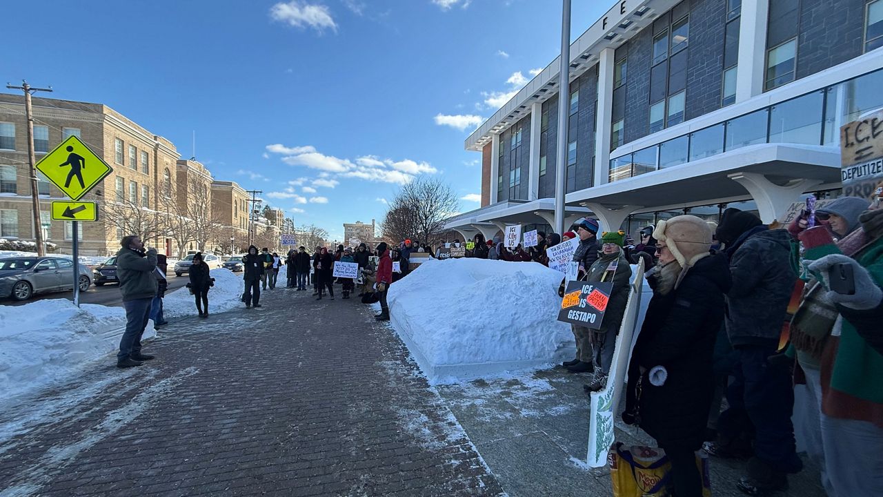 Democratic U.S Senate Candidate Graham Platner (left) speaks to protesters outside of Bangor’s federal building on Thursday. (Spectrum News/David Ledford)