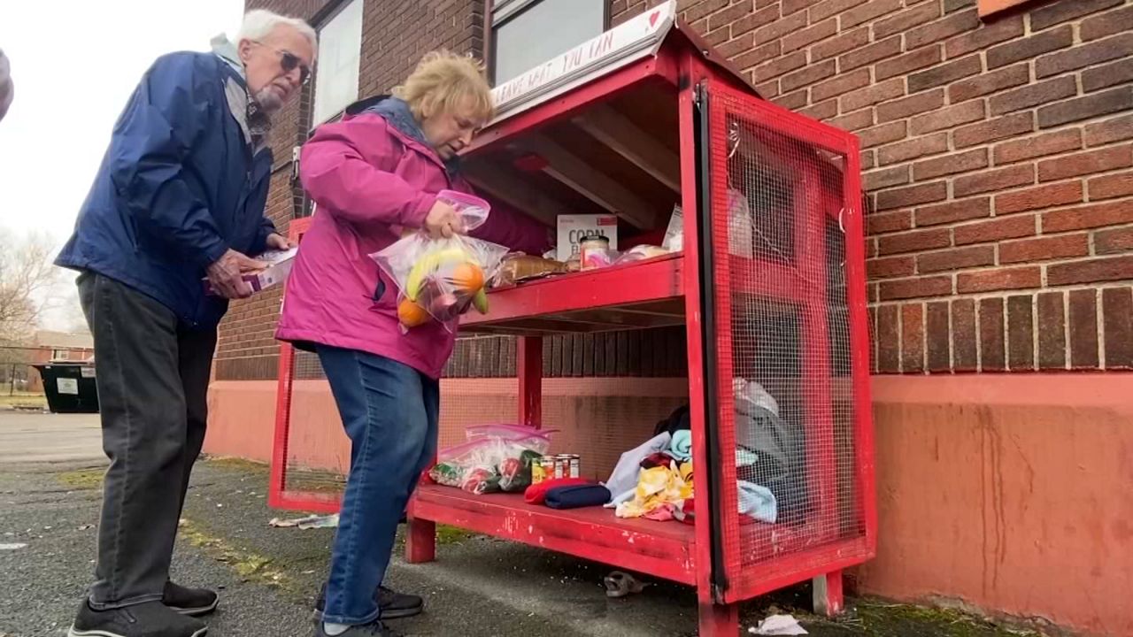 The Simmons stop at a food cupboard in Rochester
