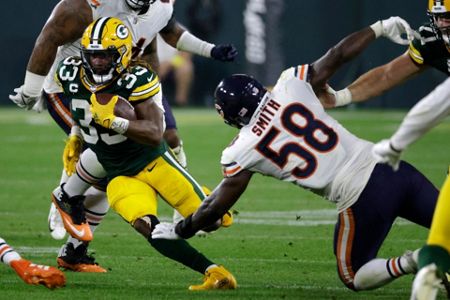 Green Bay Packers' Aaron Jones celebrates his touchdown run during the  first half of an NFL football game against the Chicago Bears Sunday, Sept.  18, 2022, in Green Bay, Wis. (AP Photo/Morry