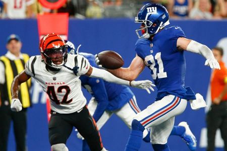 New York Giants wide receiver Collin Johnson (15) runs toward Cincinnati  Bengals' Tre Flowers (33) during the first half of a preseason NFL football  game Sunday, Aug. 21, 2022, in East Rutherford