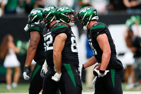 New York Jets' Michael Carter, left, runs the ball during the first half of  an NFL football game against the Cincinnati Bengals, Sunday, Oct. 31, 2021,  in East Rutherford, N.J. (AP Photo/Noah