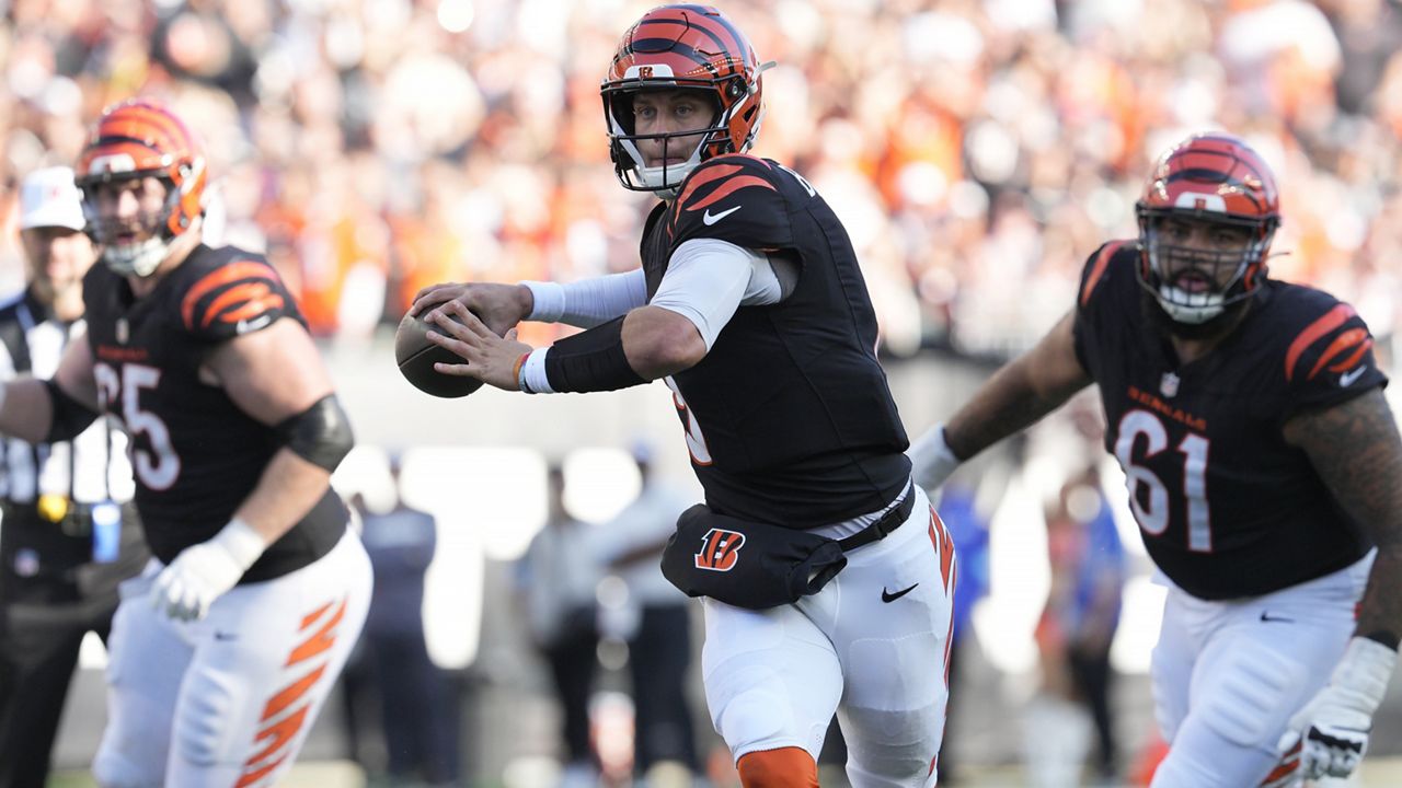 Cincinnati Bengals quarterback Joe Burrow, middle, passes against the Las Vegas Raiders during the second half of an NFL football game in Cincinnati, Sunday, Nov. 3, 2024. (AP Photo/Jeff Dean)