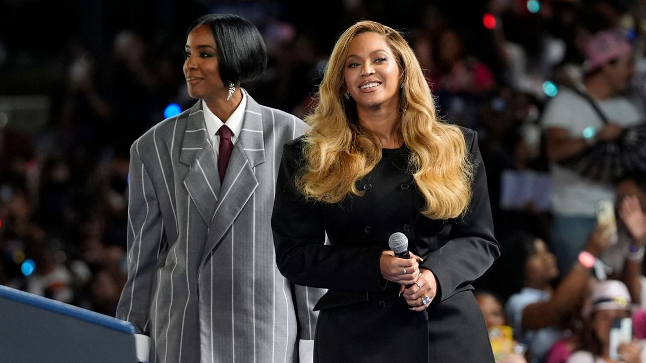 Musical artists Beyonce, right, and Kelly Rowland, left, on stage at a campaign event for Democratic presidential nominee Vice President Kamala Harris in Houston, Friday, Oct. 25, 2024. (AP Photo/Susan Walsh)