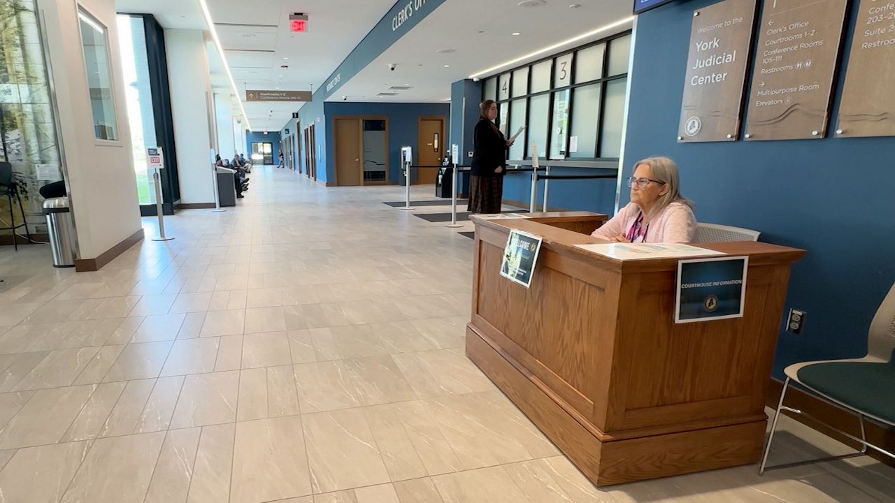 Denise Ryan is one of two volunteers who work at York County Superior Courthouse in Biddeford, directing people to courtrooms and other locations. (Spectrum News/Sean Murphy)