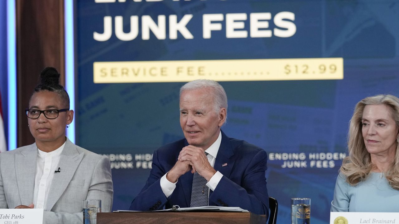 President Joe Biden speaks in the South Court Auditorium on the White House complex in Washington, Thursday, June 15, 2023, to highlight his administration's push to end so-called junk fees that surprise customers. Tobi Parks, CEO of xBk, left, and Lael Brainard, Assistant to the President and Director of the National Economic Council, right, listen. (AP Photo/Susan Walsh)
