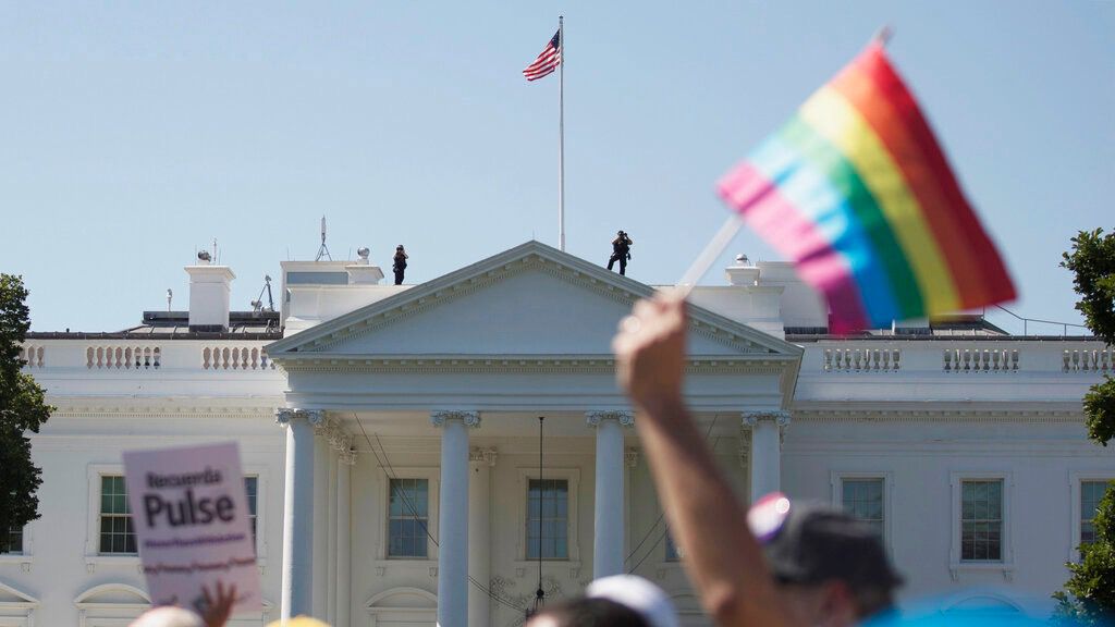 In this Sunday, June 11, 2017 file photo, Equality March for Unity and Pride participants march past the White House in Washington. (AP Photo/Carolyn Kaster)