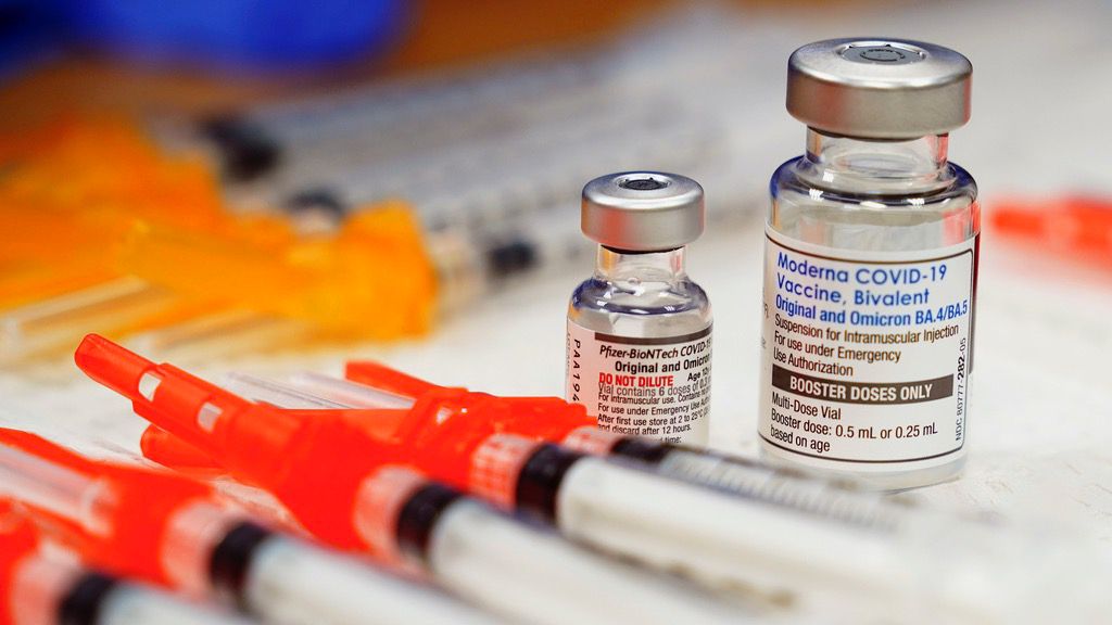 Pfizer, left, and Moderna bivalent COVID-19 vaccines are readied for use at a clinic, Nov. 17, 2022, in Richmond, Va. (AP Photo/Steve Helber)