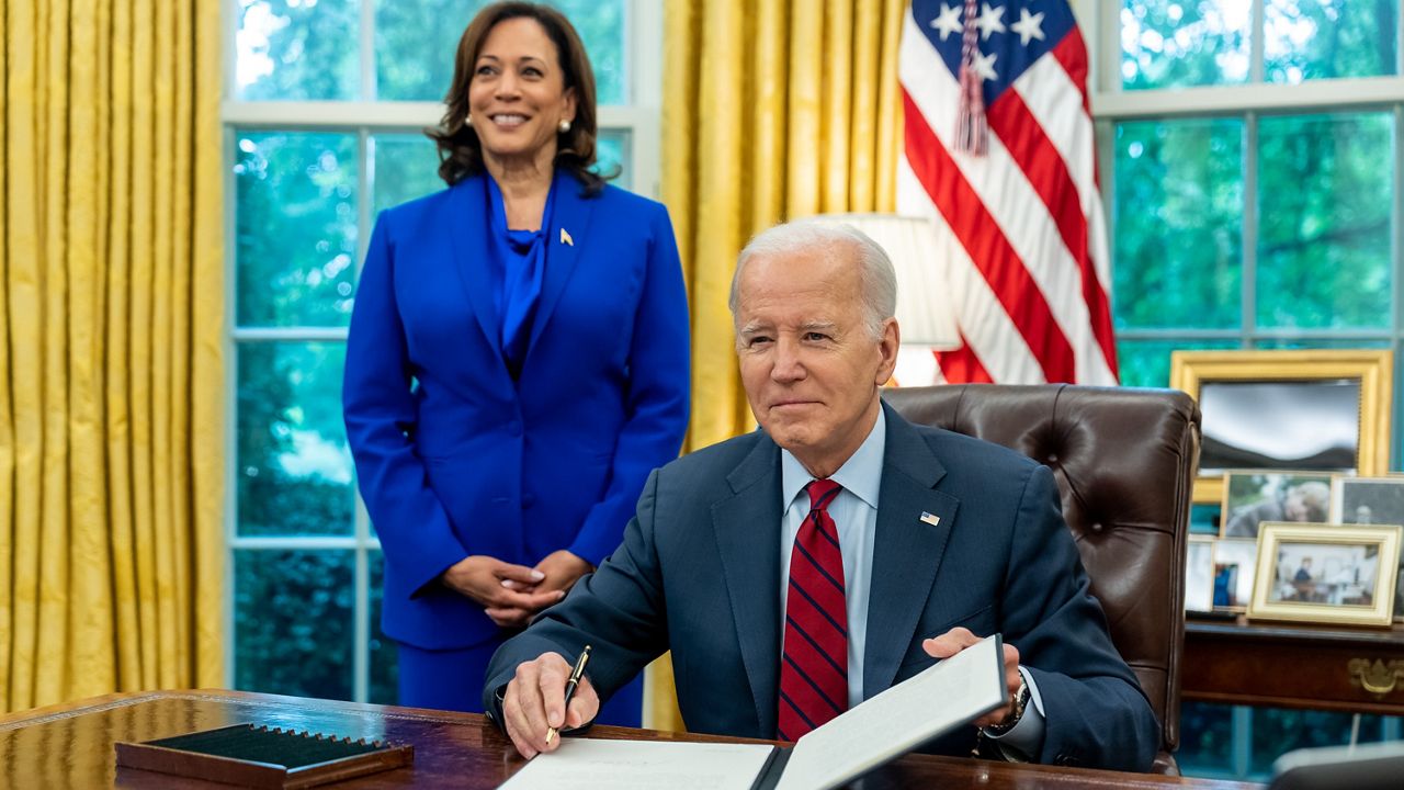 President Joe Biden signs an executive order aimed at expanding access to contraception, with Vice President Kamala Harris standing behind him in the Oval Office on Friday, June 23, 2023. (Twitter / VP)