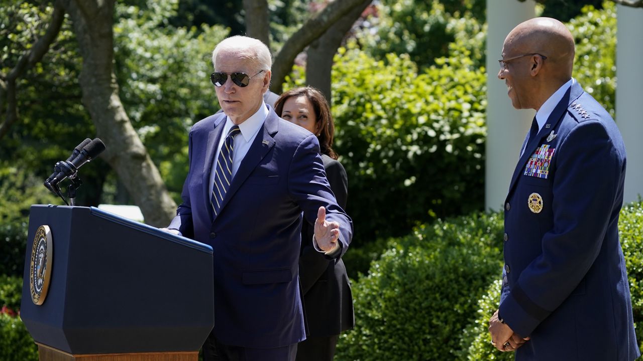 President Joe Biden gestures towards U.S. Air Force Chief of Staff Gen. CQ Brown, Jr., right, as he speaks in the Rose Garden of the White House in Washington, Thursday, May 25, 2023, on his intent to nominate Brown to serve as the next Chairman of the Joint Chiefs of Staff. Vice President Kamala Harris looks on. (AP Photo/Evan Vucci)