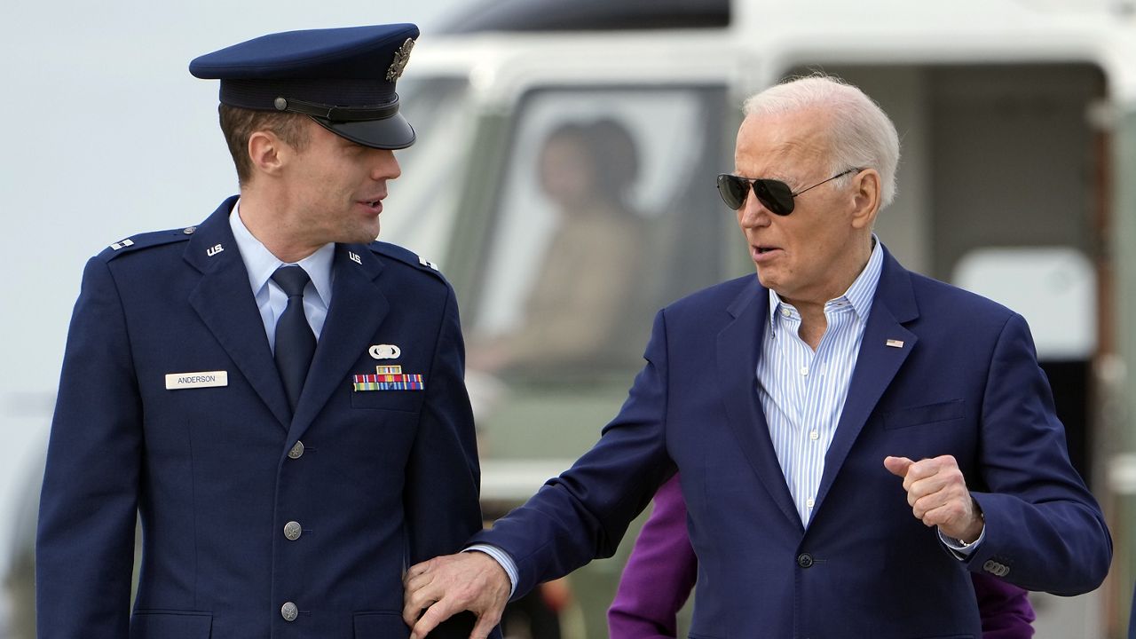 President Joe Biden walks with Capt. Eric Anderson, deputy director of flightline protocol for the 89th Airlift Wing, before leaving Andrews Air Force Base, Md., Friday, March 8, 2024, to travel to Philadelphia, for a campaign event. (AP Photo/Manuel Balce Ceneta)