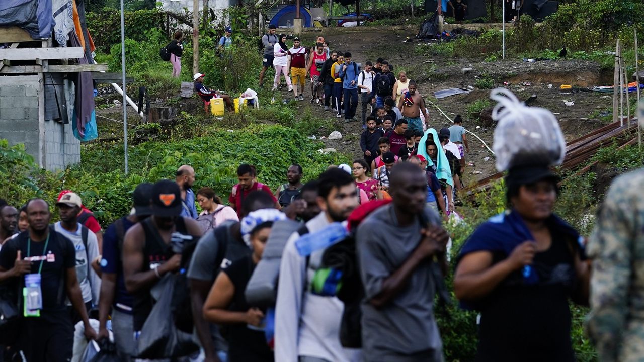 Migrants heading north line up to take a boat, in Bajo Chiquito, Darien province, Panama, Thursday, Oct. 5, 2023, after walking across the Darien Gap from Colombia. (AP Photo/Arnulfo Franco)