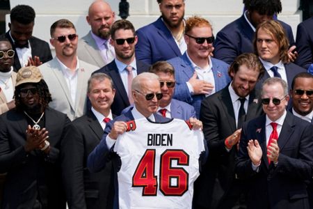 Washington, United States. 20th July, 2021. U.S. President Joe Biden, holds  a number 46 jersey handed to him by Super Bowl Champions Tampa Bay  Buccaneers owner Bryan Glazer, on the South Lawn