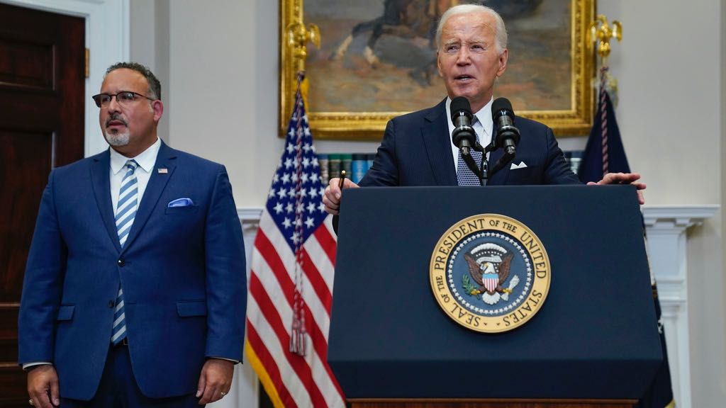 President Joe Biden speaks as Education Secretary Miguel Cardona listens at the White House, June 30, 2023, in Washington. (AP Photo/Evan Vucci, File)
