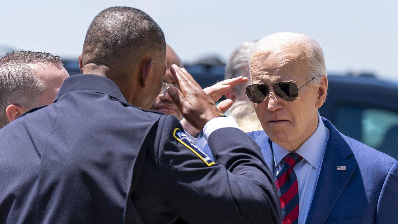 President Joe Biden salutes Charlotte-Mecklenburg Police Department Chief Johnny Jennings, as he arrives on Air Force One at Charlotte Douglas International Airport, Thursday, May 2, 2024, in Charlotte, N.C. Biden is meeting with the families of law enforcement officers shot to death on the job. (AP Photo/Alex Brandon)