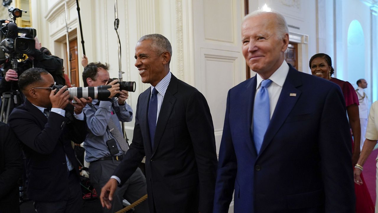 President Joe Biden and former President Barack Obama, followed by first lady Jill Biden and former first lady Michelle Obama, arrive in the East Room of the White House in Washington, Wednesday, Sept. 7, 2022, for the unveiling of the Obama's official White House portraits. (AP Photo/Andrew Harnik)