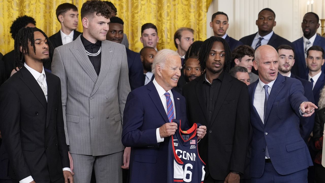 President Joe Biden holds a Huskies team jersey in the East Room of the White House in Washington, Tuesday, Sept. 10, 2024, during an event to welcome the University of Connecticut Huskies Men's basketball team and celebrate their 2023-2024 NCAA championship season. (AP Photo/Susan Walsh)