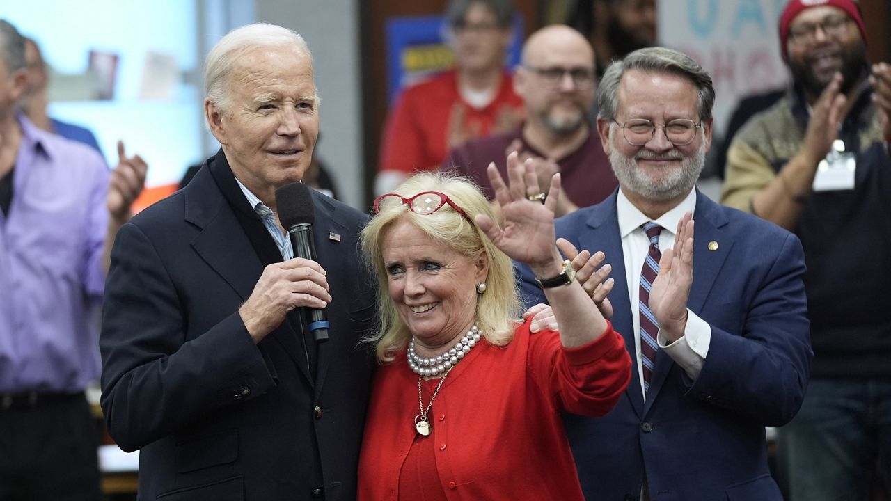 President Joe Biden, from left, Rep. Debbie Dingell, D-Mich., and Sen. Gary Peters, D-Mich., meet with UAW members during a campaign stop at a phone bank in the UAW Region 1 Union Hall, Thursday, Feb. 1, 2024, in Warren, Mich. (AP Photo/Evan Vucci)