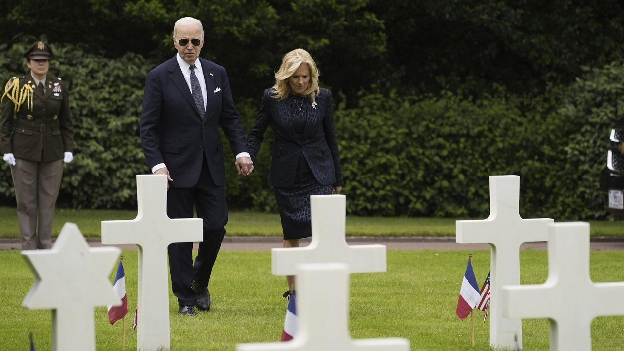 President Joe Biden and first lady Jill Biden walk in the Normandy American Cemetery following a ceremony to mark the 80th anniversary of D-Day, Thursday, June 6, 2024, in Normandy. (AP Photo/Evan Vucci)