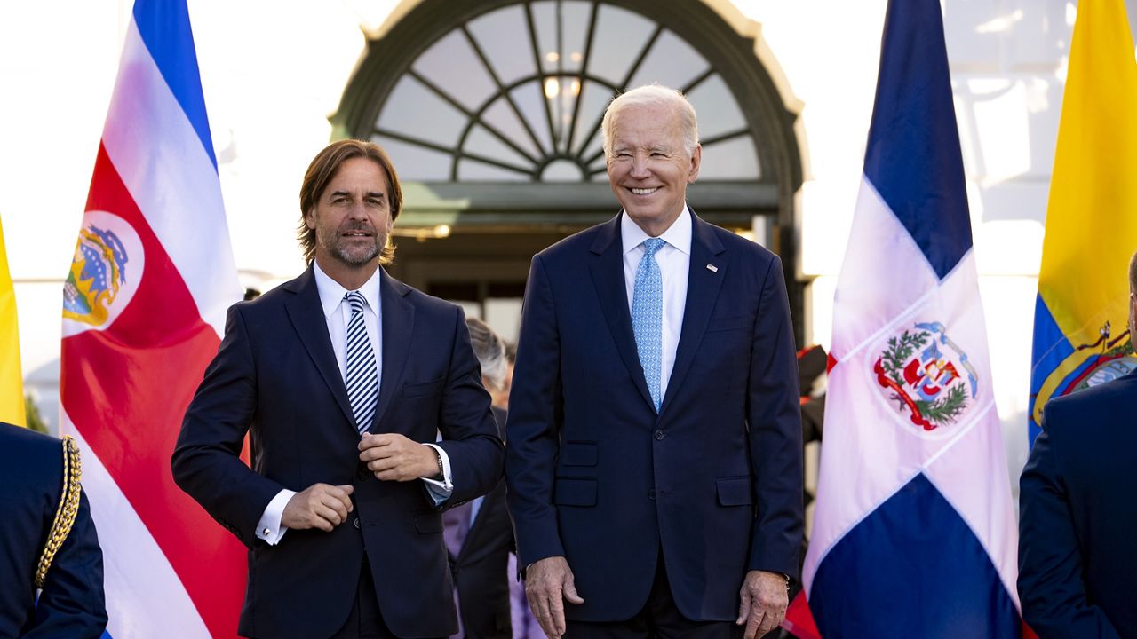 President Luis Lacalle Pou of Uruguay, left, and President Joe Biden arrive for a family photo on the South Portico for the inaugural Americas Partnership for Economic Prosperity Leaders' Summit at the White House, Friday, Nov. 3, 2023, in Washington. (AP Photo/Andrew Harnik)