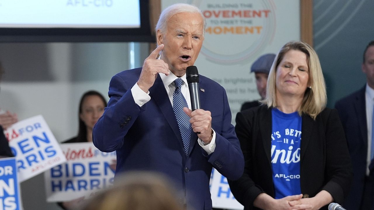 President Joe Biden speaks during a visit to AFL-CIO headquarters, Wednesday, July 10, 2024, in Washington, as AFL-CIO president Liz Shuler, right, listens. (AP Photo/Evan Vucci)