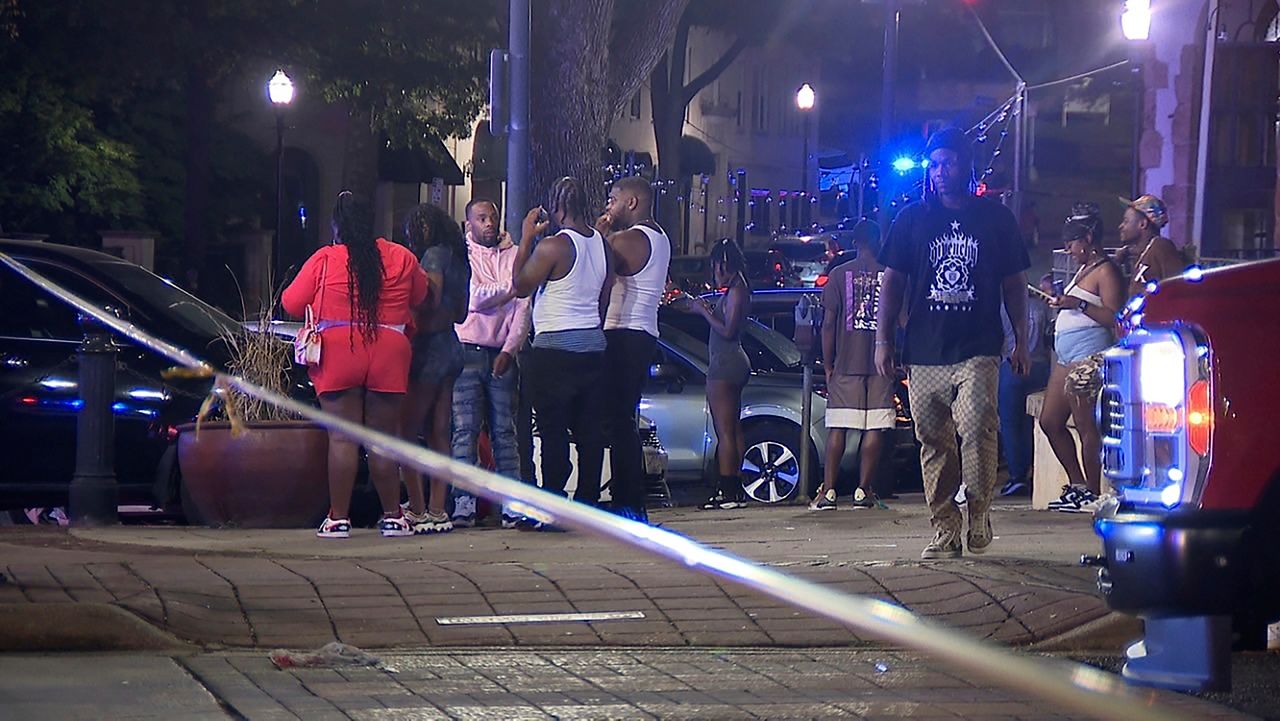 This image provided by WBMA shows bystanders near the scene of a shooting in Birmingham, Ala., Sunday, Sept. 22, 2024. (Bill Castle/WBMA via AP)