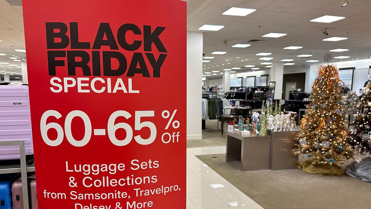 A sign announces Black Friday specials on luggage sets inside a Macy's department store on Monday, Nov. 20, 2023, in Denver. Retailers are kicking off the unofficial start of the holiday shopping season on Friday with a bevy of discounts and other enticements. (AP Photo/David Zalubowski)