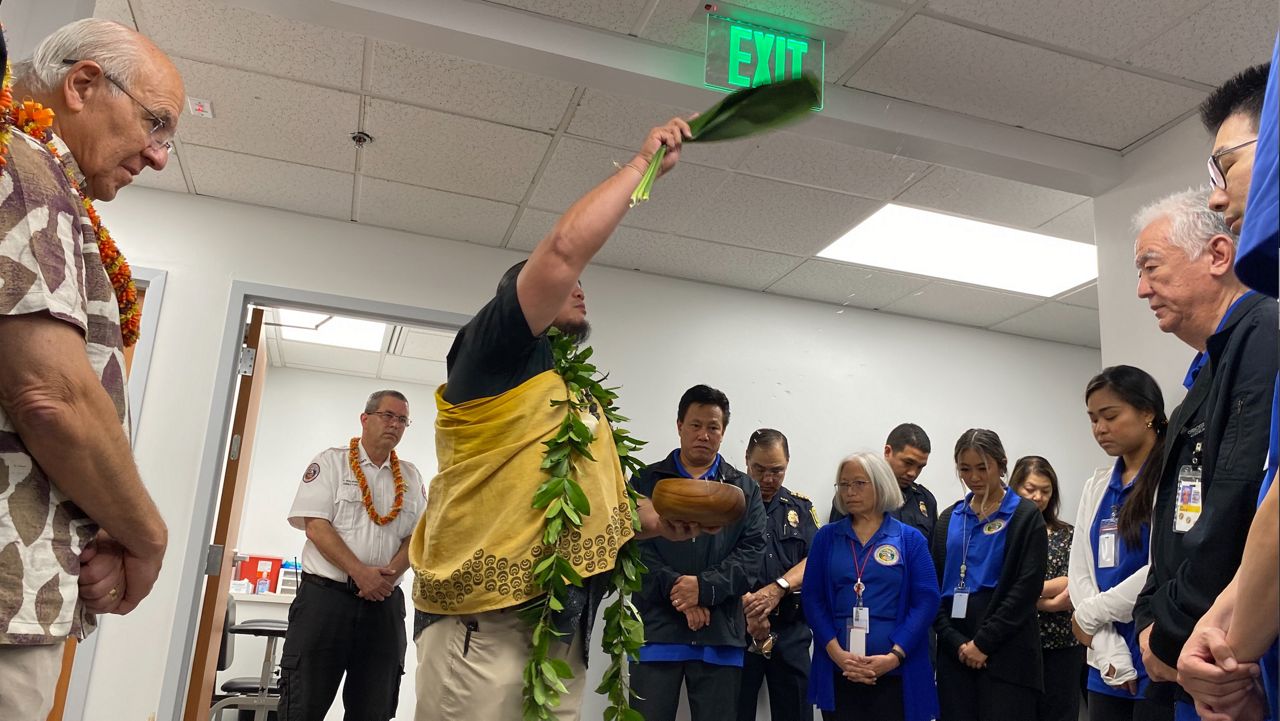 Honolulu Mayor Rick Blangiardi (left) looks on as Kahu Brutus LaBenz performs a blessing for the new Health Services Branch facility on Tuesday. (Emergency Medical Services)