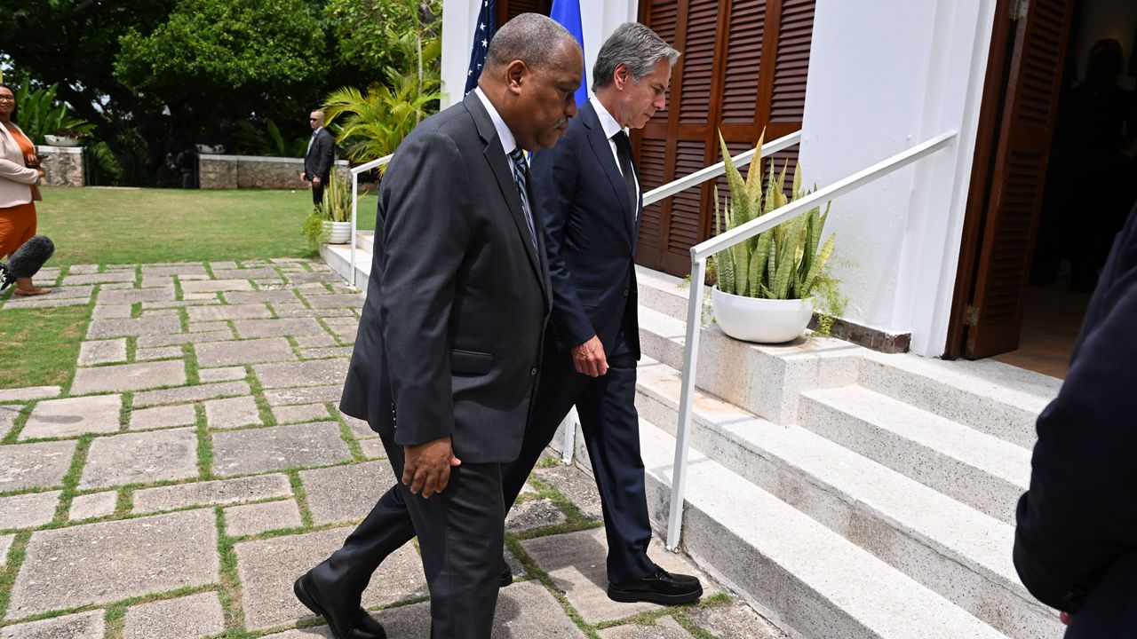 Haitian Prime Minister Garry Conille, front, and U.S. Secretary of State Antony Blinken enter the U.S. Chief of Mission Residence after speaking to the press in Port-au-Prince, Haiti, Thursday, Sept. 5, 2024. (Roberto Schmidt/Pool photo via AP)