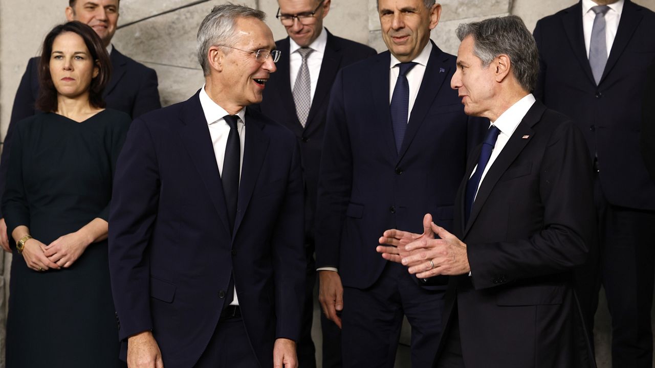 United States Secretary of State Antony Blinken, second right, speaks with NATO Secretary General Jens Stoltenberg, center left, during a group photo of NATO foreign ministers at NATO headquarters in Brussels, Tuesday, Nov. 28, 2023. NATO foreign ministers on Tuesday begin a two-day meeting in which the alliance will reaffirm its support for Ukraine's defense against Russia's invasion, explore ways of easing tensions between Kosovo and Serbia and look at preparations for NATO's 75th anniversary next year. (AP Photo/Geert Vanden Wijngaert)