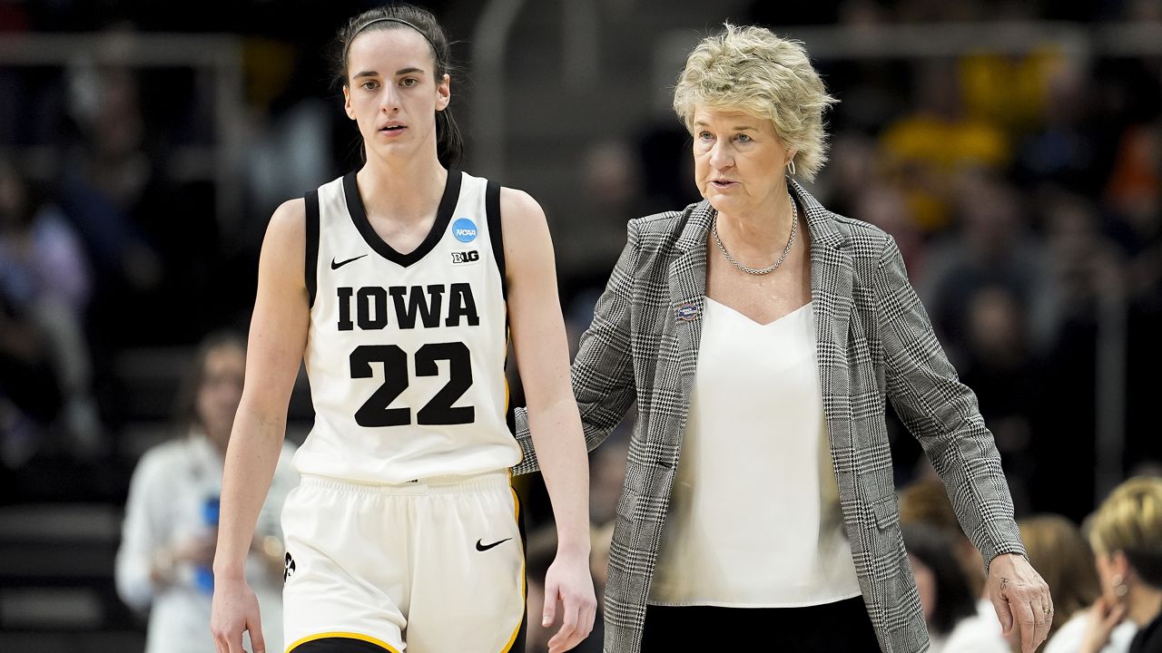 Iowa head coach Lisa Bluder, right, talks with guard Caitlin Clark (22) during the fourth quarter of a Sweet Sixteen round college basketball game against Colorado during the NCAA Tournament, Saturday, March 30, 2024, in Albany, N.Y. (AP Photo/Mary Altaffer)