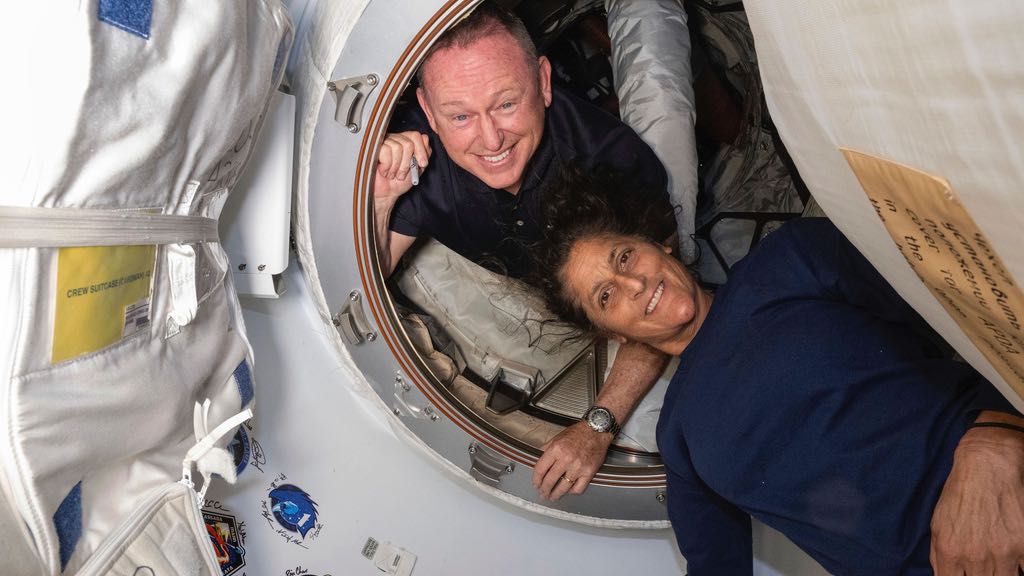 In this photo provided by NASA, Boeing Crew Flight Test astronauts Butch Wilmore, left, and Suni Williams pose for a portrait inside the vestibule between the forward port on the International Space Station's Harmony module and Boeing's Starliner spacecraft on June 13, 2024. (NASA via AP, File)