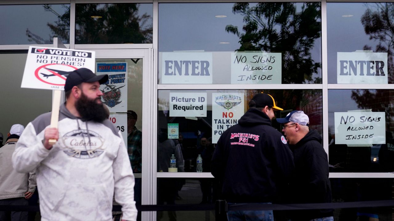 Boeing employees on strike enter a voting location to cast their ballots on a new contract offer from the company, Wednesday, Oct. 23, 2024, at the Angel of the Winds Arena in Everett, Wash. (AP Photo/Lindsey Wasson)