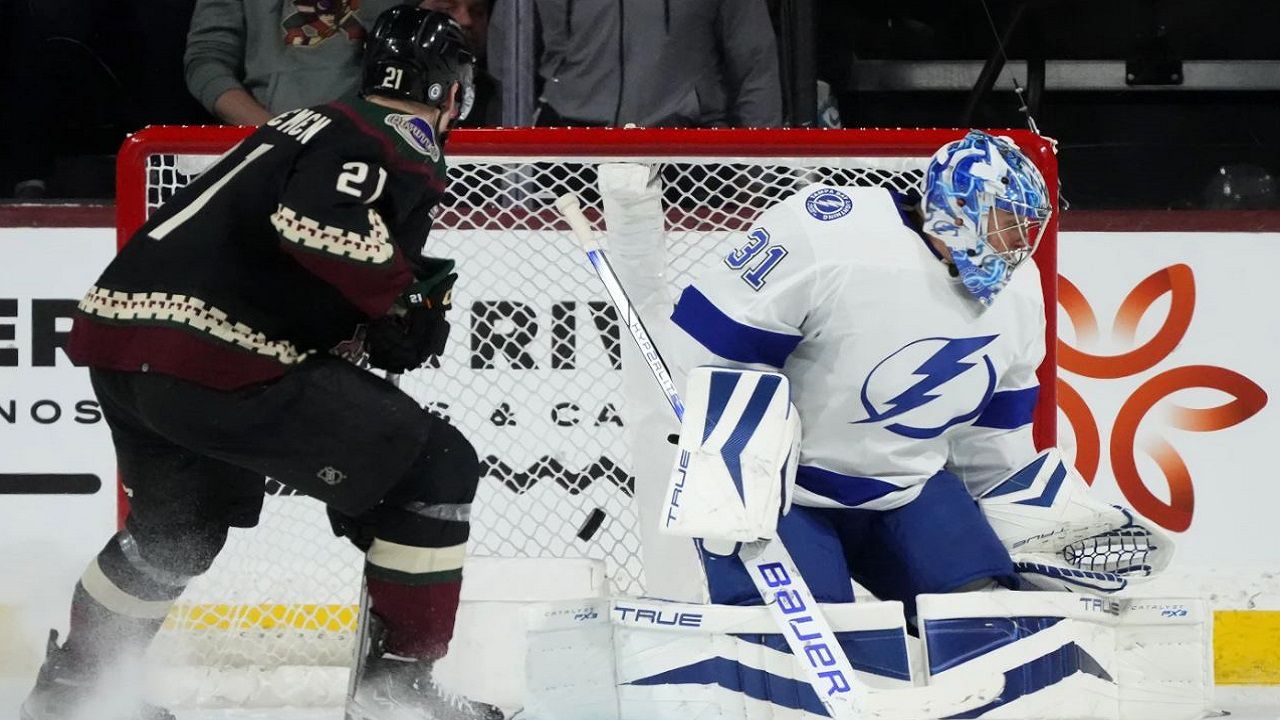 Tampa Bay Lightning goaltender Jonas Johansson gives up a goal to Arizona's Travis Boydas Milos Kelemen (21) looks on during the second period of their NHL game Tuesday night in Tempe, Ariz. (AP Photo/Ross D. Franklin)