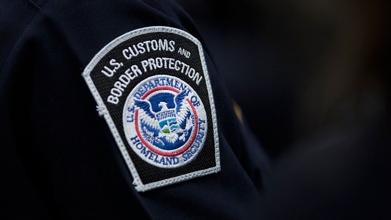 A customs agent wears a patch for the U.S. Customs and Border Protection agency, Oct. 27, 2017, at John F. Kennedy International Airport in New York. (AP Photo/Mark Lennihan, file)