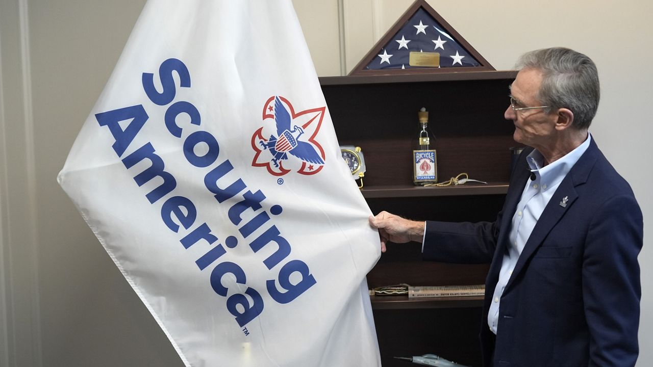 Roger Krone, chief executive officer of Scouting America, describes the design of the organization's flag in Irving, Texas, Wednesday, Feb. 5, 2025. (AP Photo/LM Otero)