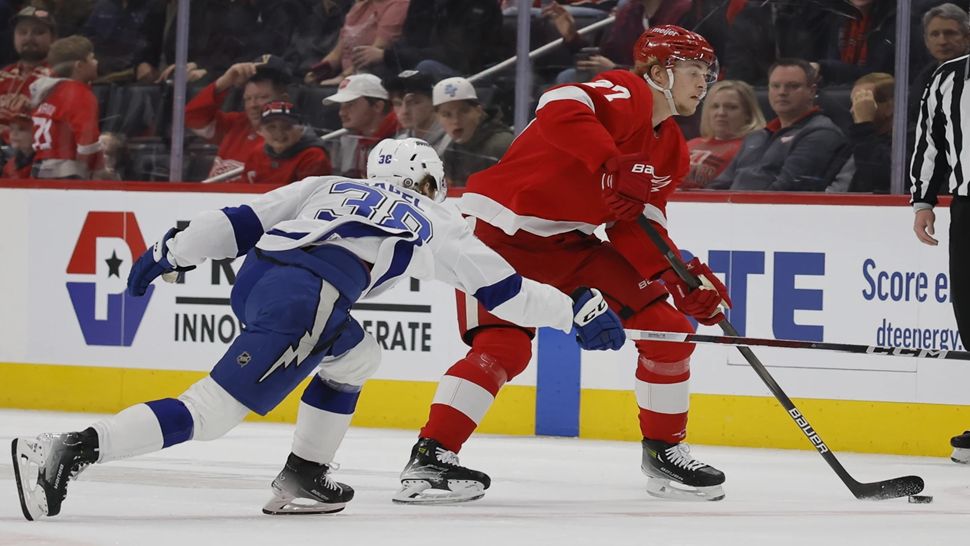 Tampa Bay forward Brandon Hagel reaches for the puck in the first period of Saturday's game against Detroit.