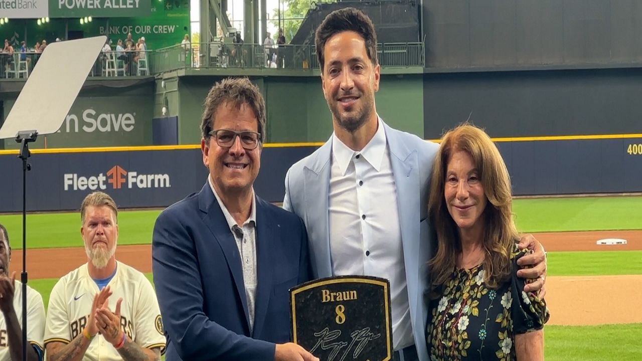 Braun (middle) awarded with replica of Walk of Fame plaque with Mark Attasanio (left) and Debbie Attasanio (right)