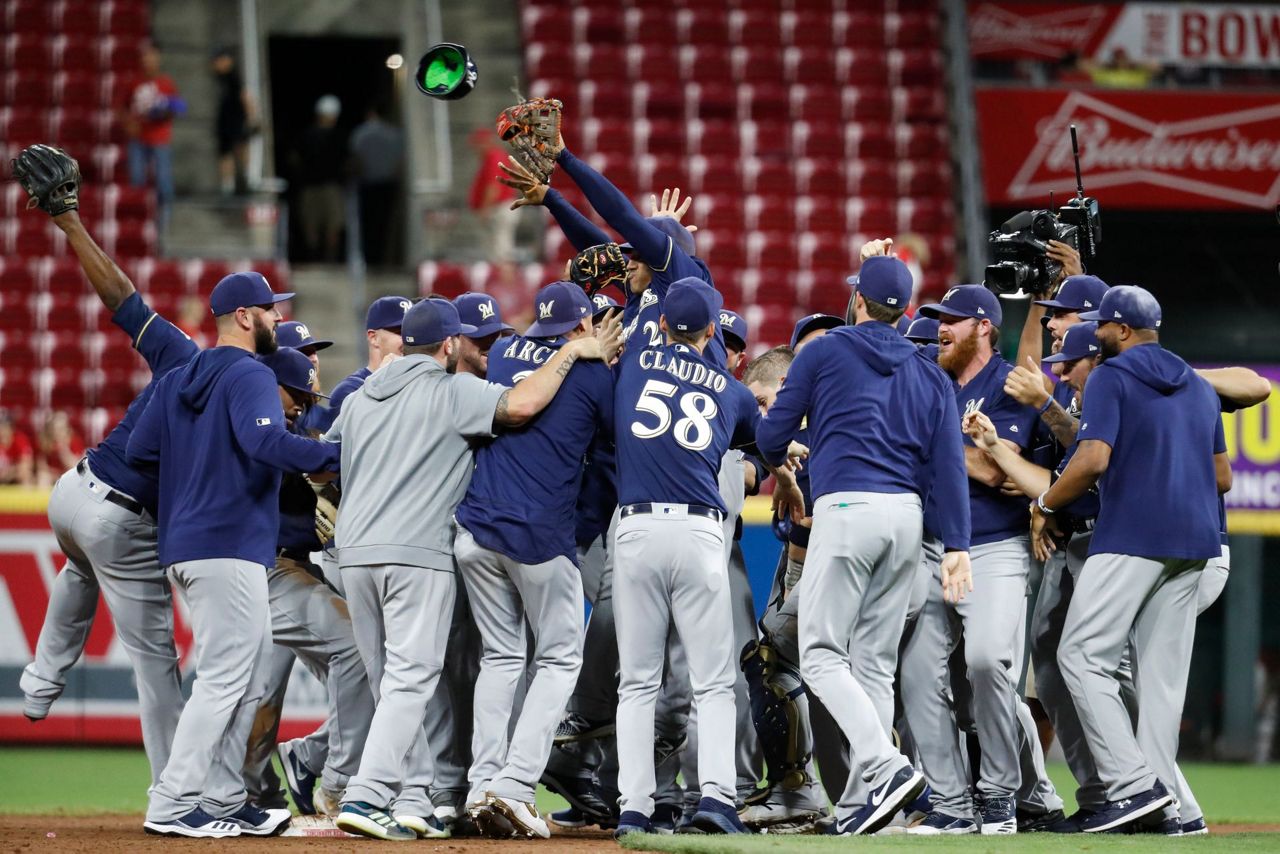 Surging Brewers clinch playoff berth with 92 win over Reds