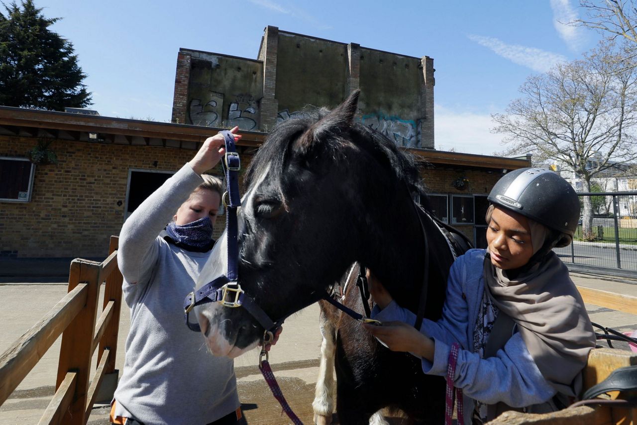AP PHOTOS: London riding club inspires children to saddle up