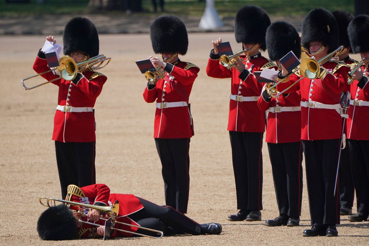 Troops feel the heat, and several faint, as Prince William reviews