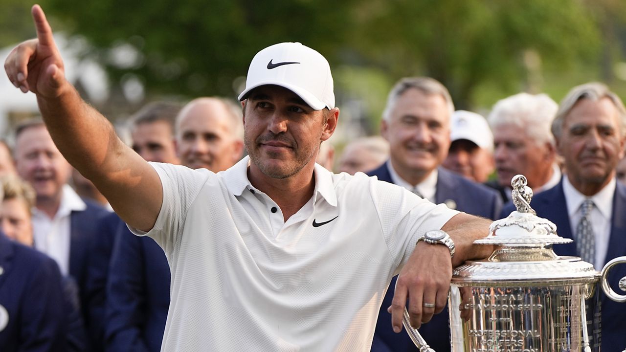 Brooks Koepka celebrates with the Wanamaker trophy after winning the PGA Championship golf tournament at Oak Hill Country Club on Sunday, May 21, 2023, in Pittsford, N.Y.(AP Photo/Eric Gay)