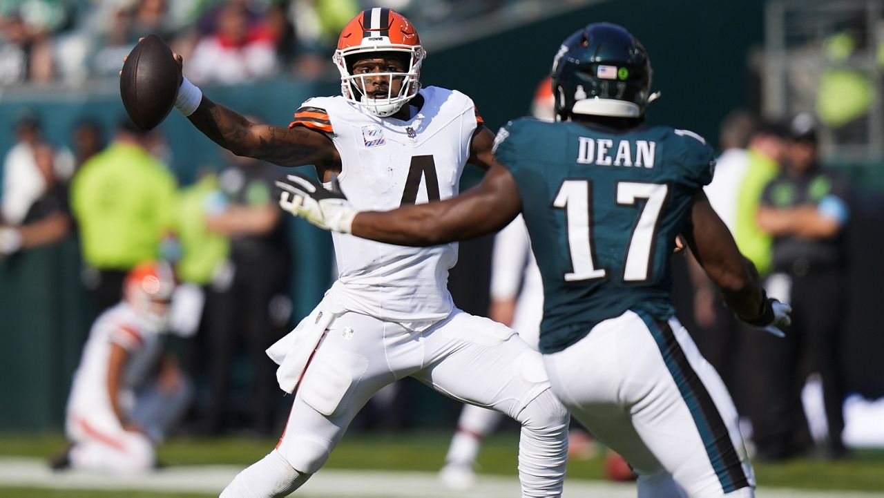 Cleveland Browns quarterback Deshaun Watson (4) scrambles with the ball as Philadelphia Eagles linebacker Nakobe Dean (17) defends during the second half of an NFL football game Sunday, Oct. 13, 2024, in Philadelphia. (AP Photo/Chris Szagola)