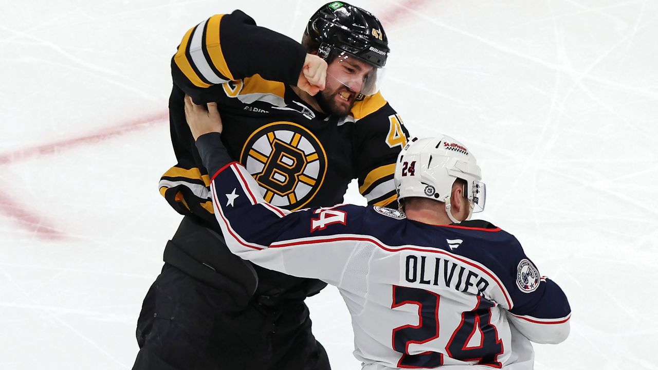 Boston Bruins forward Mark Kastelic (47) and Columbus Blue Jackets' Mathieu Olivier (24) fight during the first period of an NHL hockey game Saturday, Dec. 28, 2024, in Boston.